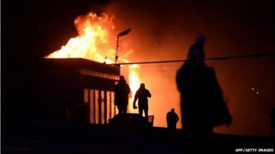 Protesters set fire to a public storage building during clashes