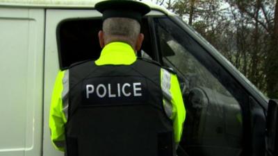 Police officer speaks to driver at drink driving awareness facility