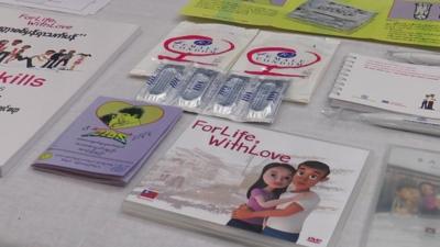 Collection of HIV AIDS awareness pamphlets and condoms