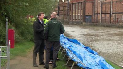 David Cameron examining flood defences
