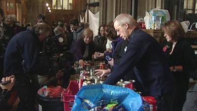 Archbishop of Canterbury Justin Welby sorting cans of food