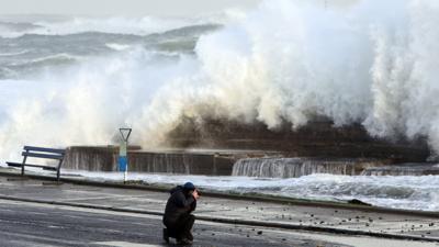 Man takes picture as huge wave breaks in Portrush