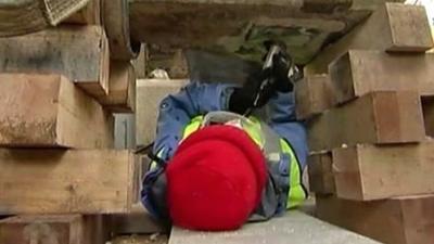 A construction worker removing a time capsule from granite