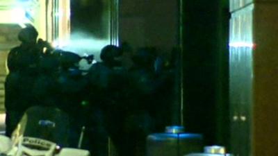 Police storm the cafe in Sydney