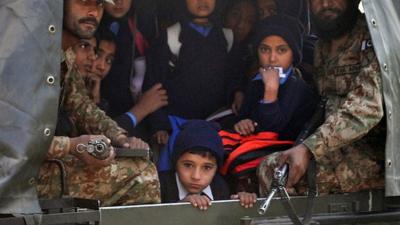 Children and soldiers in Pakistani army vehicle