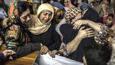 Women mourn their relative Mohammed Ali Khan, 15, a student who was killed during an attack by Taliban gunmen