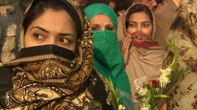 Women with floral tributes