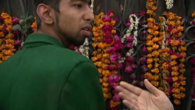 Pakistan school attack survivor Aqif Azeem shows BBC reporter faint blood stains on his school uniform