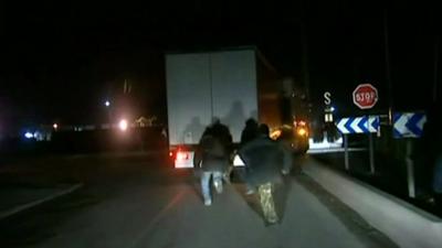 Migrants try to get into a lorry