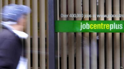 Blurred image of man walking past Job Centre