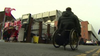 Wheelchair using fan outside a sports ground