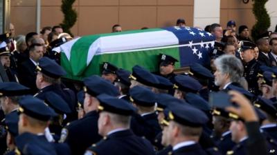 Police officers and coffin of Officer Ramos