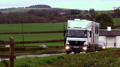 Mobile chemo van driving through rolling countryside