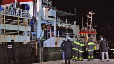 Italian police look at migrants aboard the cargo ship "Ezadeen" after the vessel arrived in the southern Italian port of Corigliano, Italy, 03 January 2015