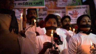 Indian political and civil society activists take part in a vigil to mark the second anniversary of the fatal gang-rape of a student in the Indian capital, at the bus stop in the Munirka area of New Delhi on December 16, 2014.