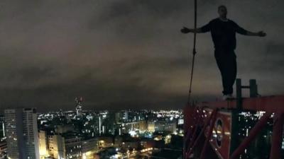 James Jefferies climbing a crane