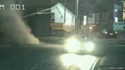 CCTV footage of streetlight and dust as building collapses on road in Wrexham