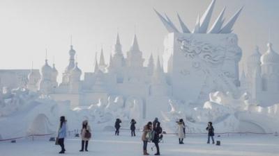 Visitors look at snow sculptures during the 16th Harbin International Ice and Snow Festival in Harbin, northeast China"s Heilongjiang province on January 5, 2015