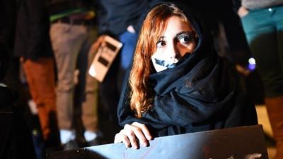 A woman takes part in a gathering on the Old Harbor in Marseille