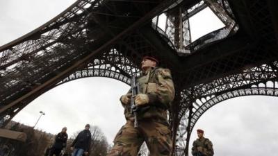 A French soldier patrols near the Eiffel Tower