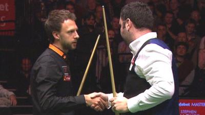 Judd Trump shakes hands with Stephen Maguire