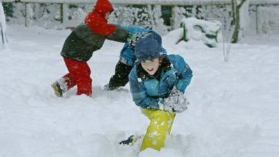 Children playing in snow in Scotland