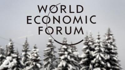 The logo of World Economic Forum (WEF) logo in front of snow-covered trees, file pic from 2012