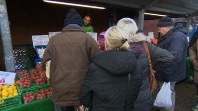 Some pension-age people at a market stall