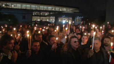 Crowd holding candles