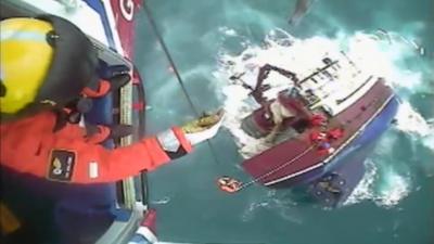 Crew rescued from sinking boat