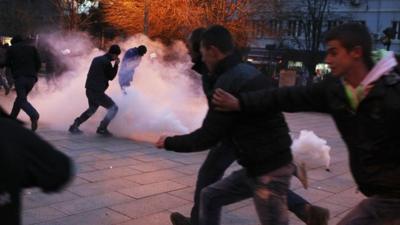 Protesters react to tear gas