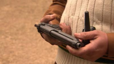 Teacher holds gun