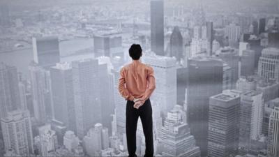 Man from behind looking over large city