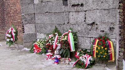 Wreaths laid against the 'Death Wall' at Auschwitz