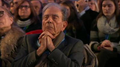 A man contemplates during the ceremony at Aushwitz