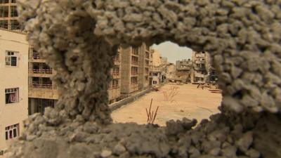 View through hole in damaged Benghazi wall