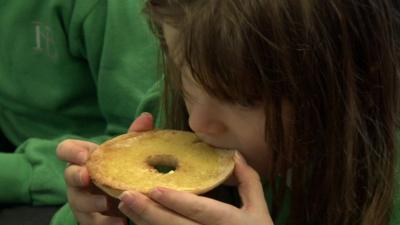 Child eating a breakfast bagel