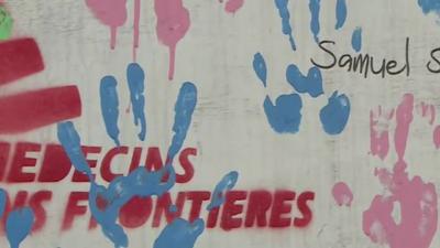 Close up of handprints in paint on an Ebola survivors' mural in an MSF centre in Monrovia