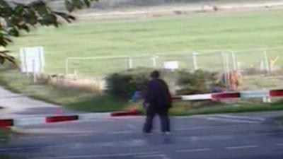 Man crosses a level crossing