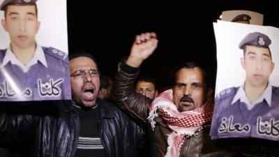 In this Tuesday, Jan. 27, 2015 photo, people from the al-Kaseasbeh tribe and other tribes take part in a demonstration outside of Jordan"s cabinet in Amman calling for the release of Jordanian pilot Lt. Mu"ath al-Kaseasbeh, who is held by Islamic State group militants, hours after militants posted a video purporting to show a Japanese hostage holding his picture with a message that both hostages would be killed within 24 hours