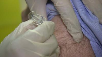 A patient receiving the fly vaccine