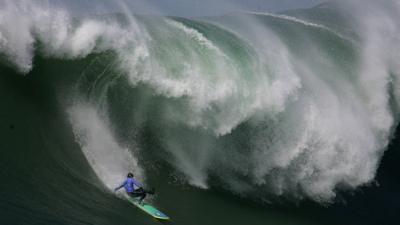 A surfer riding waves in Mavericks