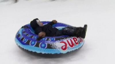 A boy in a rubber ring in the snow