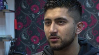 Barber, Idris Yousaf, talking to the BBC in his Wallsall barbers 'Cut n fade'