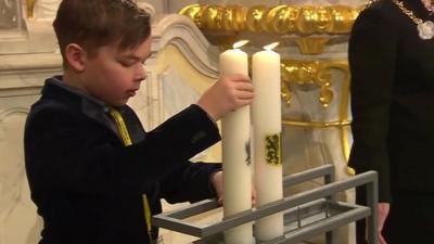 Candle being lit at Dresden commemoration ceremony