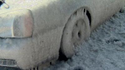 A car frozen to the road