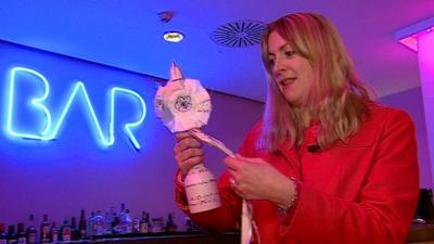 Natalie Jamieson holding a Brit award designed by Tracey Emin