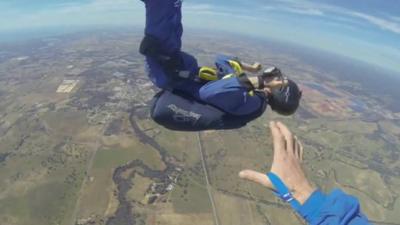 Christopher Jones in mid-air as Sheldon MacFarlane stretches out his arm to grab him