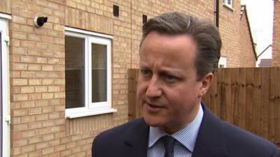 Prime Minister David Cameron speaking to the media while visiting a housing estate in Cannock