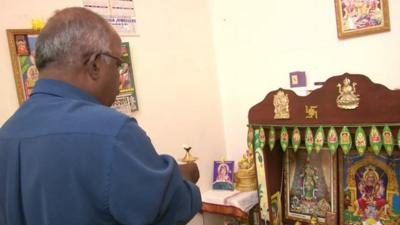 The father of one of the passengers on board MH370 praying to the Hindu gods